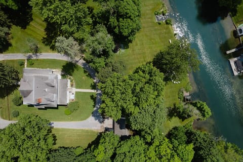 A breathtaking top-down view of Pearson House, nestled among trees with private riverfront access.