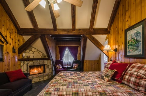 Master bedroom with real wood-burning stone fireplace