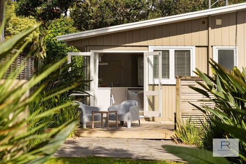 Sunny deck with lounge seating overlooking back lawn