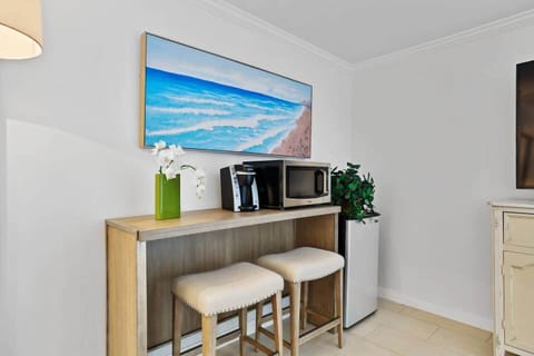 Coffee bar with microwave and mini refrigerator, hot water kettle.