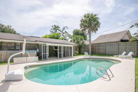 Large pool with lounging area and pool basketball hoop