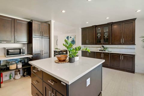 Kitchen with large island, dishwasher, sink, refrigerator, electric stove, oven