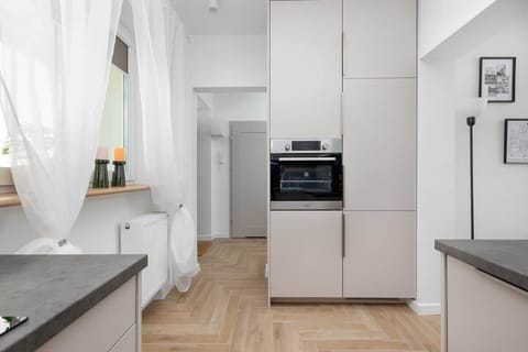A detail shot of a kitchen counter with a power outlet and fruit bowl. Clean lines and neutral tones highlight modern design.