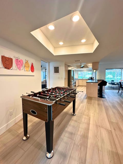 Open concept living,kitchen and dining with ample seating,foosball and golf view