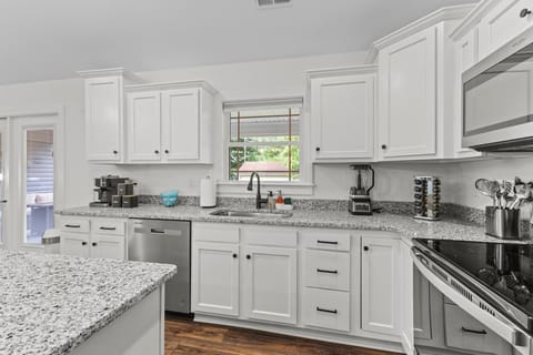 Kitchen | featuring an electric range and dishwasher
