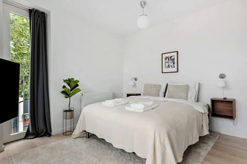 Master bedroom with direct access to private balcony and ensuite 55" Smart TV.