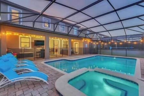 Enclosed pool and spa with covered patio