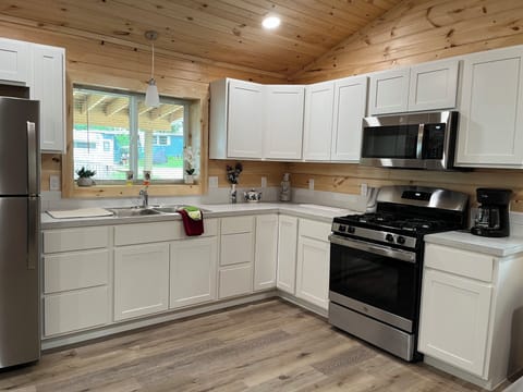 This is a completely furnished new kitchen with all you need to prepare a meal.