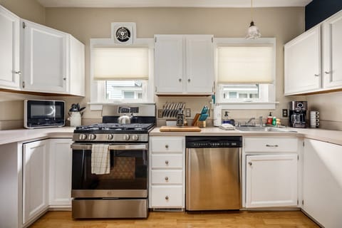 Step into this modern kitchen featuring stainless steel appliances, and ample cabinet space. Ideal for culinary enthusiasts and family gatherings alike.