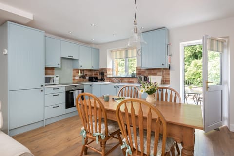 The kitchen and dining area is a functional and modern space with beautiful views over the River Greta