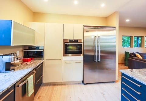 Modern kitchen with a built in 48” Viking refrigerator, Miele built in oven and Miele steam oven.