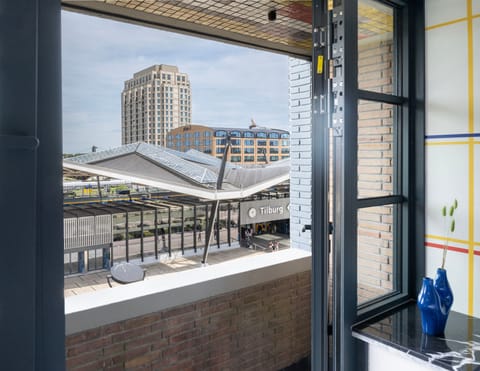 Relax on the charming balcony at Bed and Koffee Central, right in Hotel Centrum Tilburg — the perfect spot to unwind after an enchanting Efteling overnight!