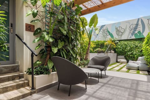 Immerse yourself in a world of charm and whimsy. Our vibrant exterior welcomes you with a sparkling pool, open-air gym, and delightful signage at every turn.
