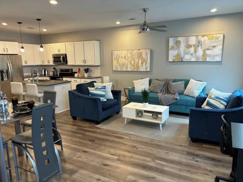 Living Room: Bright open space with modern decor, plush seating, and a stylish kitchen next door!