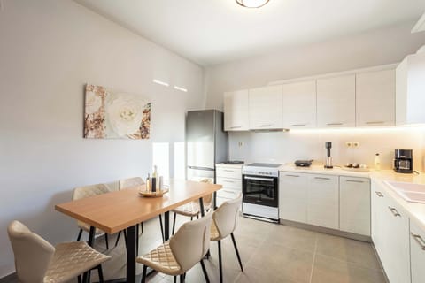 Functional Kitchen Area with Sink, Cooktop, and Dining Access

