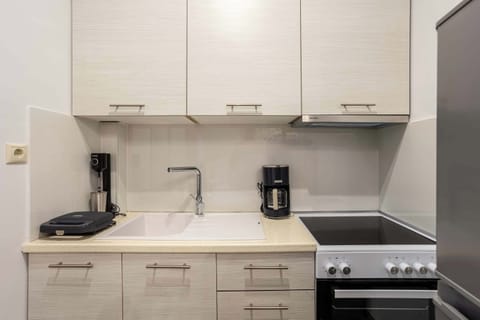 Sleek White Kitchen with Modern Cabinets and Small Appliances

