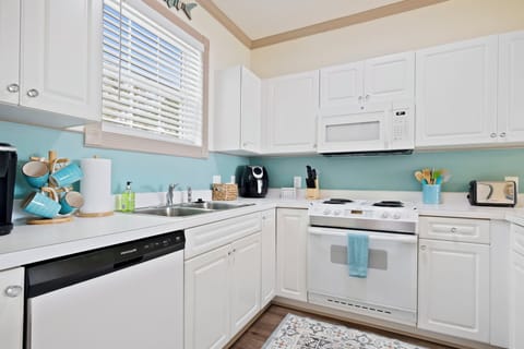 There is a coffee maker, toaster, blender, air fryer, and cooking essentials.