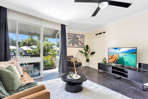 Living Room: Bright and airy space with sleek decor and a view of the lush outdoors!