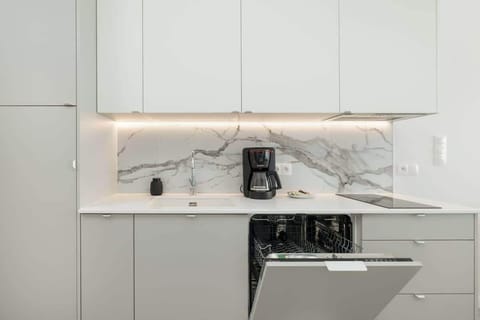 Kitchenette with plenty of kitchen utensils and dishes.