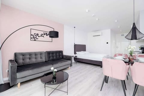 Chic living room with blush dining chairs and modern art
Elegant, inviting interior design ideal for entertaining or relaxing.

