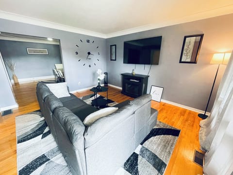 This living room features a cozy modern design with soft neutral-toned furniture