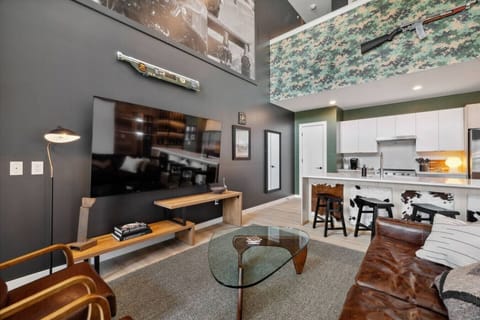 Living room with Smart TV, two queen Murphy beds, and private patio access