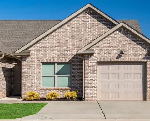 The exterior photo showcases a charming residence with a spacious driveway that comfortably accommodates two cars, ensuring convenient parking for you and your guests