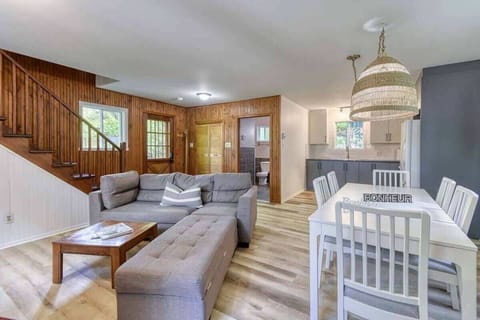 Stylish living area blending warm wood tones with cool grey and white accents for a modern, cozy feel.