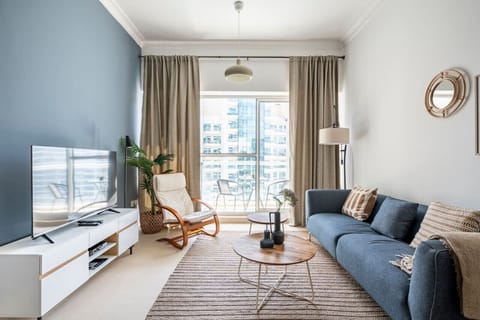 Elegant one-bedroom apartment in the Mayfair Building, Business Bay, featuring a chic living room with a canal view. Perfect for a holiday home in Dubai, vacation rental in Dubai, short-term rental in Dubai, or monthly rental in Dubai.