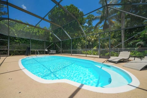 Welcome to our tranquil retreat, featuring a screened pool area that offers a perfect blend of relaxation and privacy.