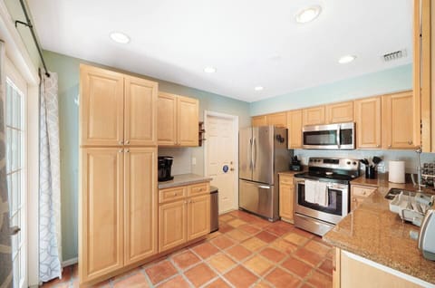 It includes a coffee maker, electric kettle, and a selection of mugs, along with a range of coffee pods and tea bags for starter.