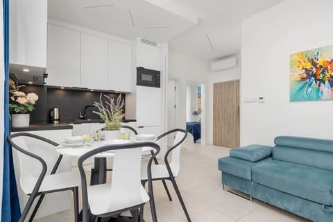 Kitchen Detail – Dark-toned modern kitchen with LED lighting, sink, and minimalistic design.

