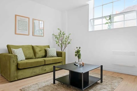 "Relax in style in our beautiful living room, featuring a cozy sofa that easily transforms into a comfy sofa bed for extra sleeping space."