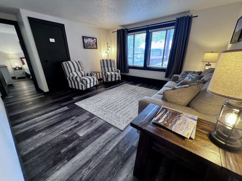 Living room includes 2 reclining chairs, queen size sleeper sofa, and Smart TV.