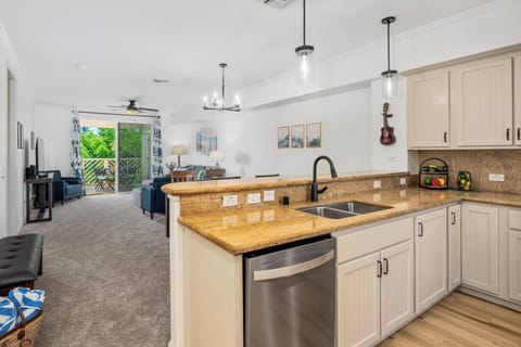 Full kitchen with breakfast bar, granite counters, and stainless steel appliances