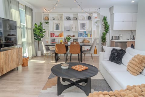 Open-concept living/dining space. Includes, TV, books, games and record player.