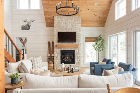 Cozy lakeside luxury - gather by the fireplace with serene views