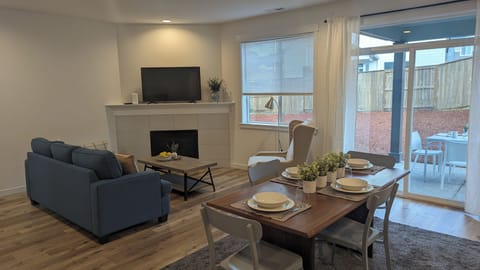 Gas fire place & flat screen tv in living room; access to patio from dining area