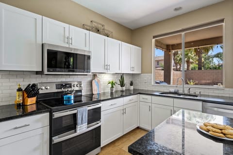 Prepare meals in a bright kitchen with a window framing picturesque outdoor views