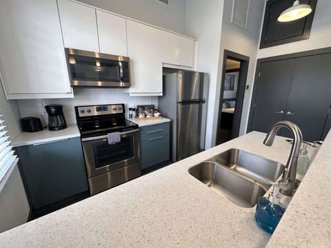 Kitchen with stainless steel appliances and bar seating