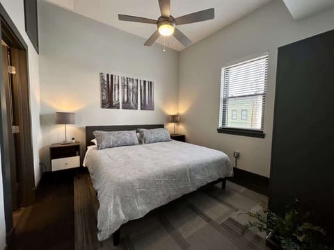 Cozy bedroom with queen bed and ceiling fan