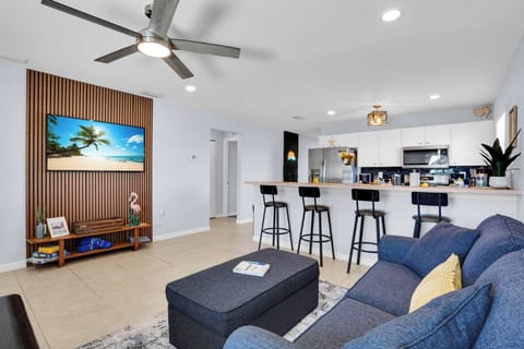 Open living and kitchen area featuring comfortable seating and a flat-screen TV.