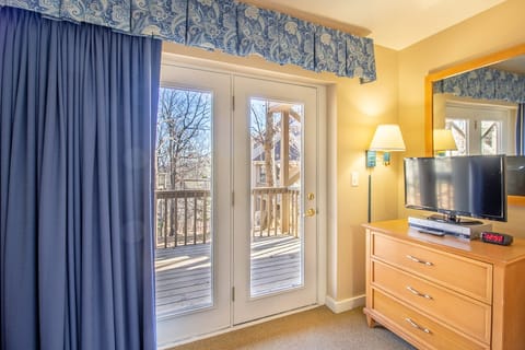 Second bedroom includes private deck access and tv