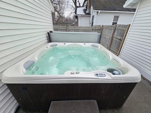 Relax and soak in this year round hot tub nestled between the garage and house.