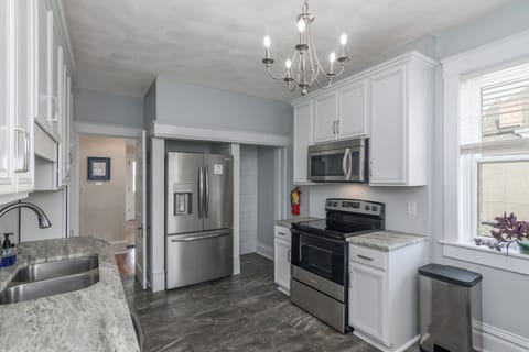 Fully functional kitchen with modern electric stove.