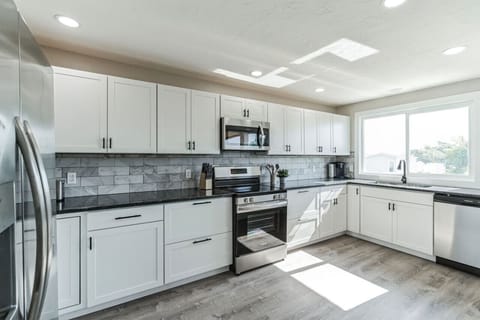 Fully equipped kitchen with stainless steel appliances and ample counter space