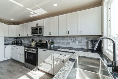Fully equipped kitchen with stainless steel appliances and ample counter space