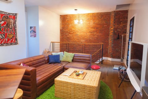 Modular living room lounge area featuring  Samsung TV and custom art & curation.