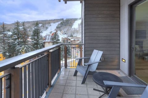 Private balcony with comfortable seating and stunning mountain views.