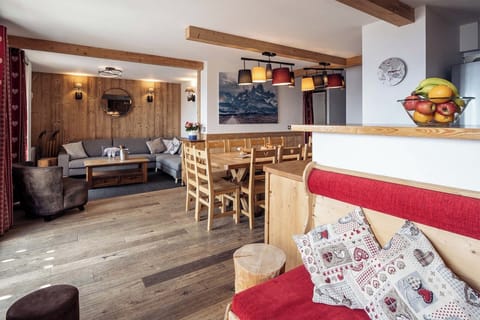 Relax in the cosy living area featuring rustic wooden beams and a welcoming ambience perfect for unwinding after a day of adventure on the slopes.
